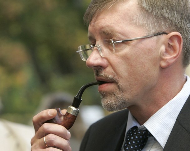 Lithuania's Prime Minister Kirkilas smokes pipe after a meeting in Dikli